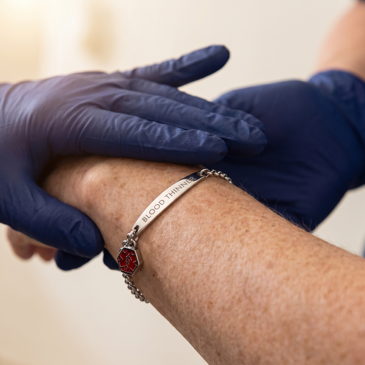 A woman in her 70s wearing the WristAlert Wrist-Check Bracelet on her left wrist